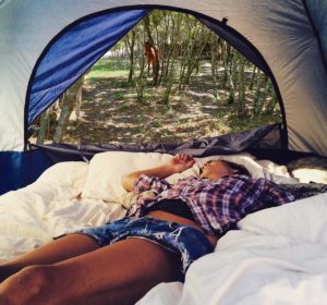 fille alongée dans une tente à la fenière